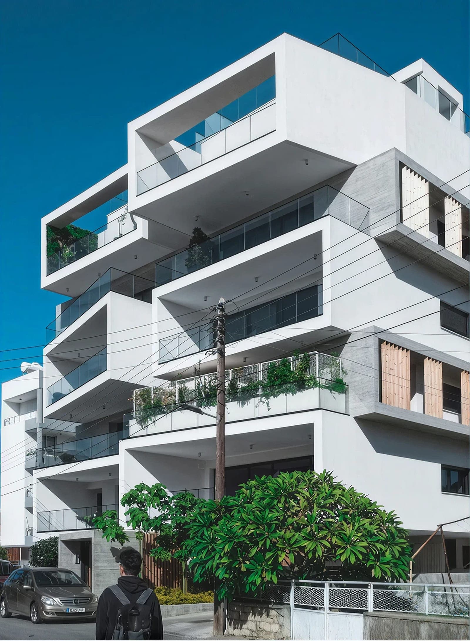 Modern white residential building with terraced balconies