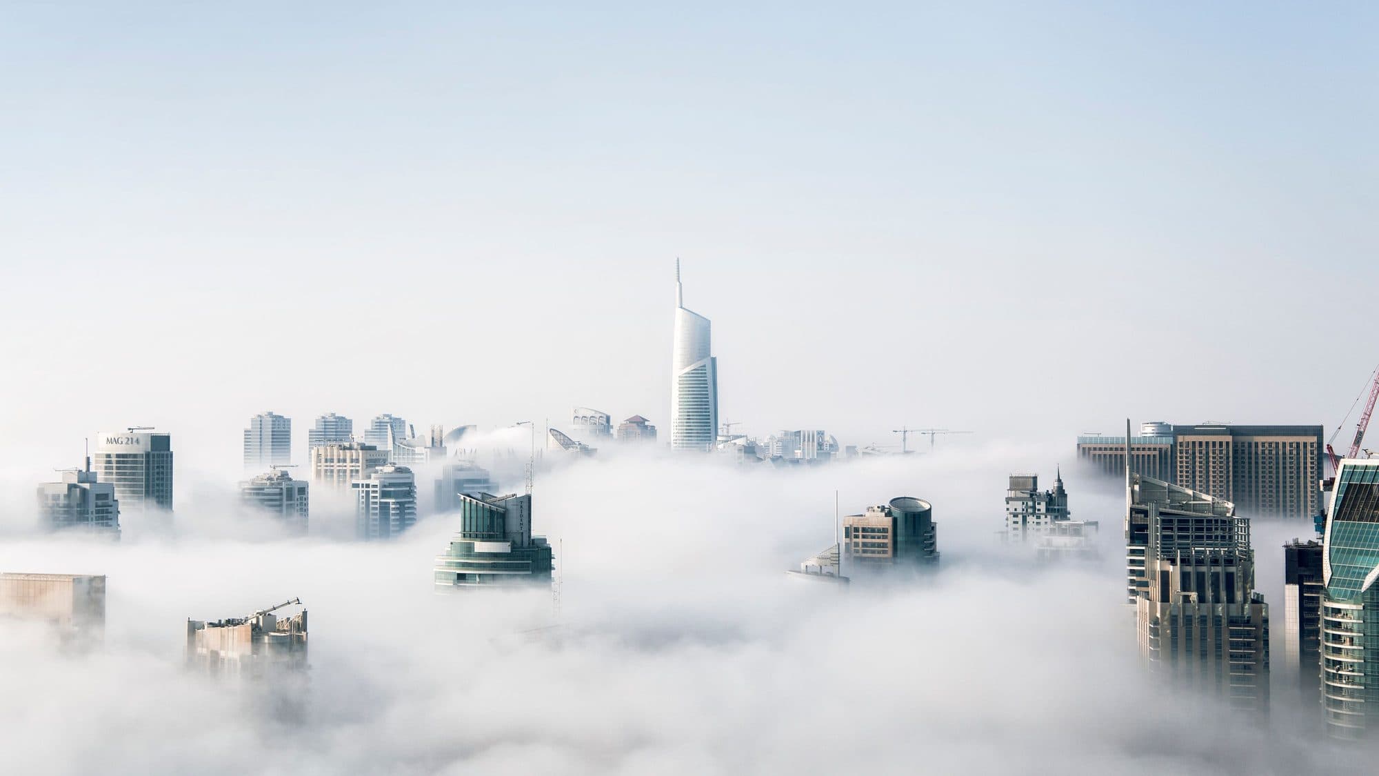 City towers rising above low cloud
